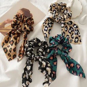 Four-pack of leopard print elastic hair scrunchies with long ribbons in diverse colors