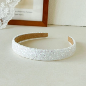 Close-up of sparkling white sequin headband with non-slip velvet inner lining