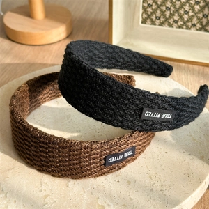 Detail showing thick knitted texture and True Fitted label on vintage hairbands