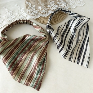 Close-up of bohemian printed elastic headbands in red and monochrome stripes