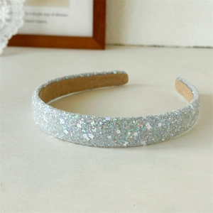 Detailed close-up of sparkling silver sequin headband with soft velvet non-slip lining
