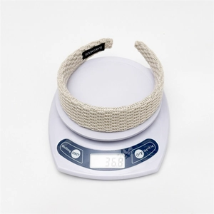 Close-up of beige woven headband on scale showing actual weight of 36.8g and handmade label