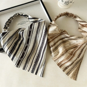 Detail of satin floral triangle headscarf with elastic band in retro stripe patterns