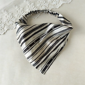 Detail of black and white geometric pattern bandana with elastic band and silk texture