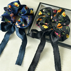 Floral print satin hair scrunchies with long streamers in navy blue and black
