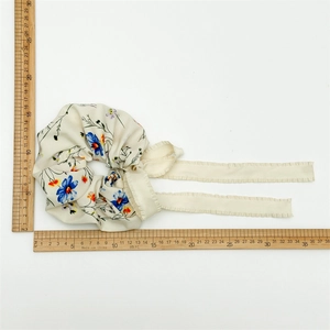 Floral fabric scrunchie with long ribbons in cream satin with colorful flower patterns