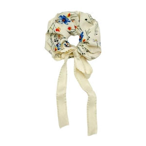 Floral print scrunchie with ribbons in cream fabric featuring blue and orange flower patterns