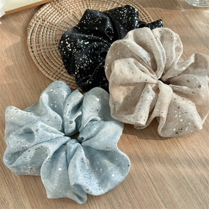 Three-piece large satin scrunchies set in black, beige, and blue with silver star prints