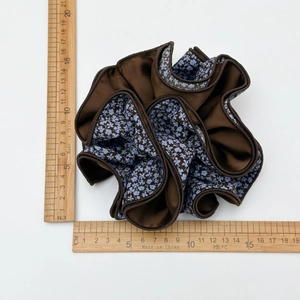 Brown and blue floral satin scrunchie shown with a ruler for size reference