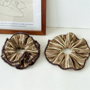 Detail of winter striped scrunchies with faux fur trim and cozy texture for hair