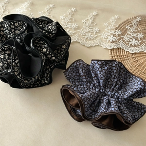 Detail of vintage floral scrunchies in black and brown with layered ruffle design