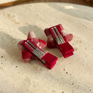 Red plaid star hair clips for children featuring polka dot beads and star fabric patterns