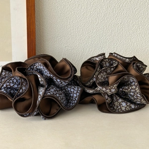 Elegant coffee brown and blue floral scrunchie hair tie with pleated satin fabric texture