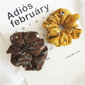Detailed view of floral chiffon scrunchies set with elegant flower patterns and soft texture