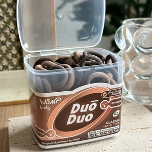 Close-up of brown elastic hair ties for kids in a transparent square storage box