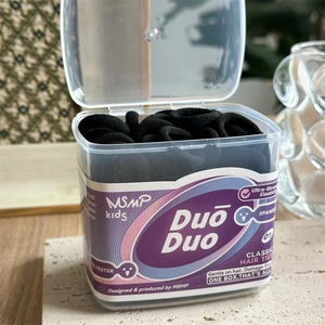 Detail of high-elastic black hair ties in a clear flip-top storage box for kids