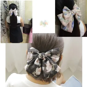 Rear view of large floral chiffon bow hair clip showing elegant drape and layered fabric detail