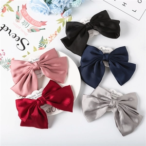 Large chiffon bow hair clips set in elegant colors with smooth satin texture and secure grip