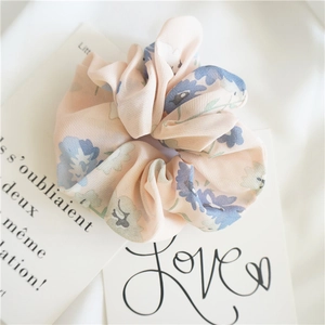Detailed view of pink floral chiffon scrunchie with blue flowers on a romantic card