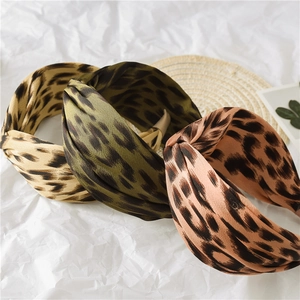 Three-color wide leopard print knotted headbands with a satin finish on white background