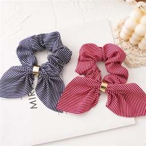 Close-up of striped chiffon scrunchies with bunny ears and elegant gold metal buckles