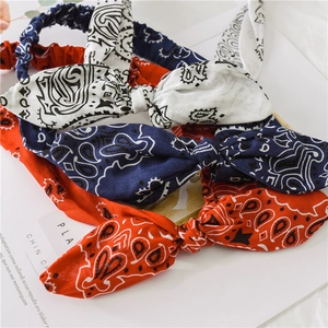 Three-piece set of paisley print wired headbands in white, navy blue, and orange-red