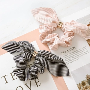 Detail of striped chiffon bunny ear scrunchies with gold metal ring decorative accents