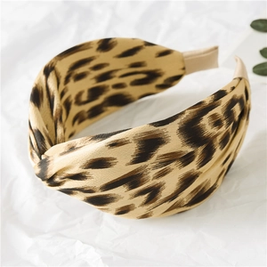Close-up of leopard print knotted wide headband with textured satin fabric details