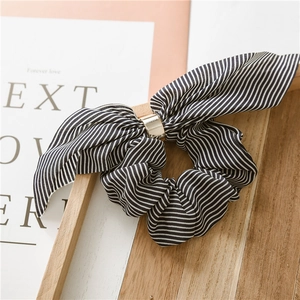 Detail of striped chiffon scrunchie with rabbit ear bow and golden metal ring