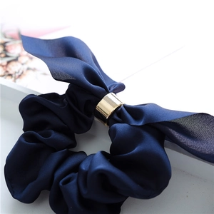 Elegant navy blue floral scrunchie with large bow and gold metal ring accent