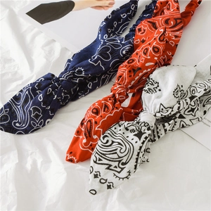Three-piece paisley wired headbands in navy, orange, and white for versatile retro styling