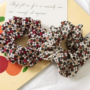 Detailed view of vintage floral scrunchies in red and green cotton fabric sets
