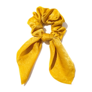 Elegant bright yellow satin hair scrunchie with long ribbons and smooth silk texture