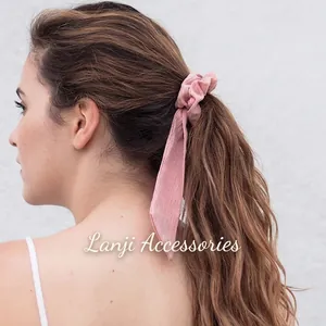 Pink ribbon scrunchie with vertical striped texture for women's high ponytail hairstyles