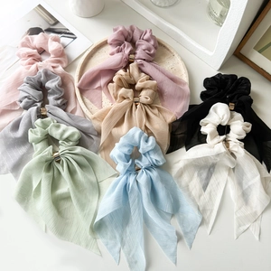 Detail of multi-color chiffon bow scrunchies with elegant gold metal buckles