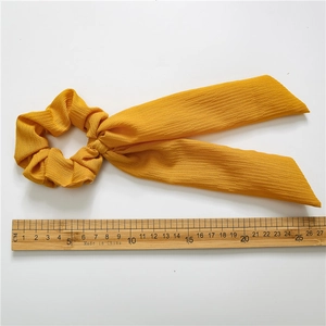Ginger yellow scrunchie with long ribbons in lightweight chiffon on white background