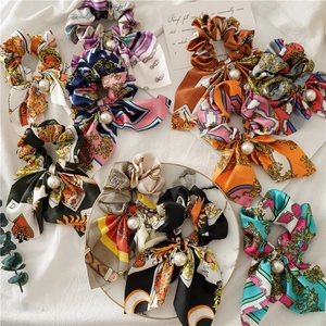 Elegant satin rabbit ear scrunchies set with pearl charms in diverse vintage patterns