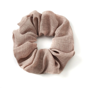 Neutral solid color cotton linen scrunchie with soft elastic texture on white background