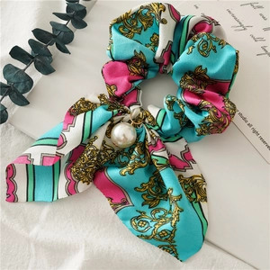 Detailed macro of baroque print scrunchie with rabbit ear ribbon and pearl pendant charm