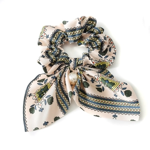 Beige floral bow scrunchie with large white pearl pendant and vintage patterns