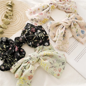Detailed set of floral chiffon bow hair clips in white, black, beige, and light green colors
