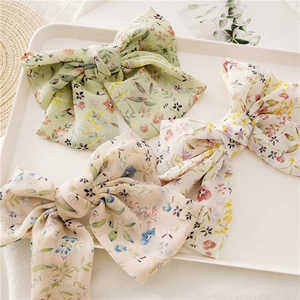 Three-piece set of large floral chiffon bow hair clips in pastel green and beige colors