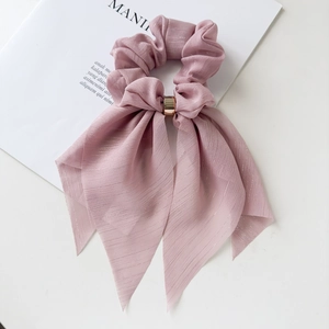 Detailed macro view of the lotus pink lace scrunchie with silver silk texture and gold buckle