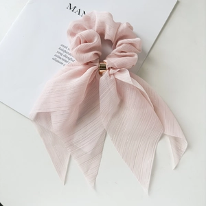 Pink pleated silk hair scrunchie with large bow and polished gold metal ring detail