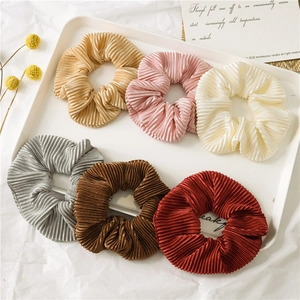 Elegant 6-pack pleated satin scrunchies in diverse metallic tones on a white display tray