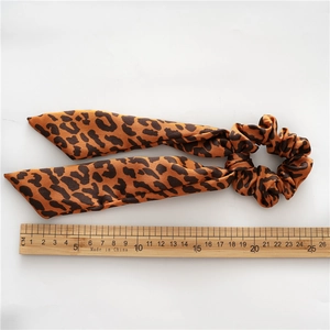 Leopard print satin scrunchie with ribbons, 25cm long, minimalist white background
