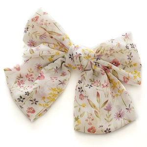 Floral print chiffon bow hair clip with colorful flower patterns on white fabric