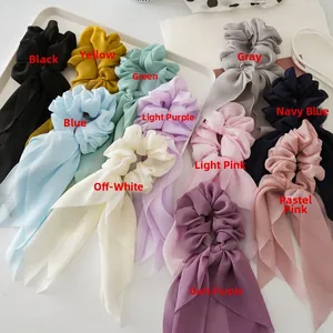 Flat lay of colorful chiffon bow hair scrunchies with long ribbons in eleven vibrant colors