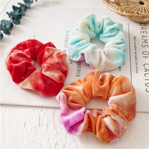 Three-piece set of tie-dye velvet scrunchies with vibrant gradients and soft texture