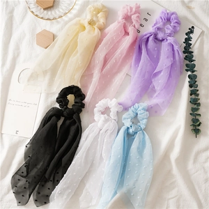 Detail of seersucker ponytail hair ties with polka dots in six assorted pastel colors